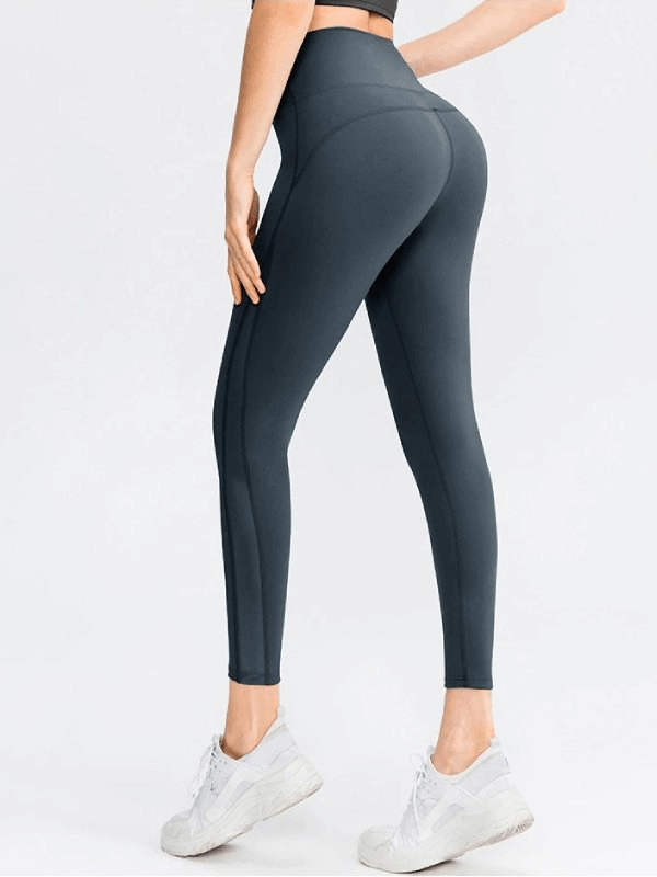 Sporty seamless women's leggings with high waist, full-length design, showcasing flexibility and comfort for yoga, in dark color.